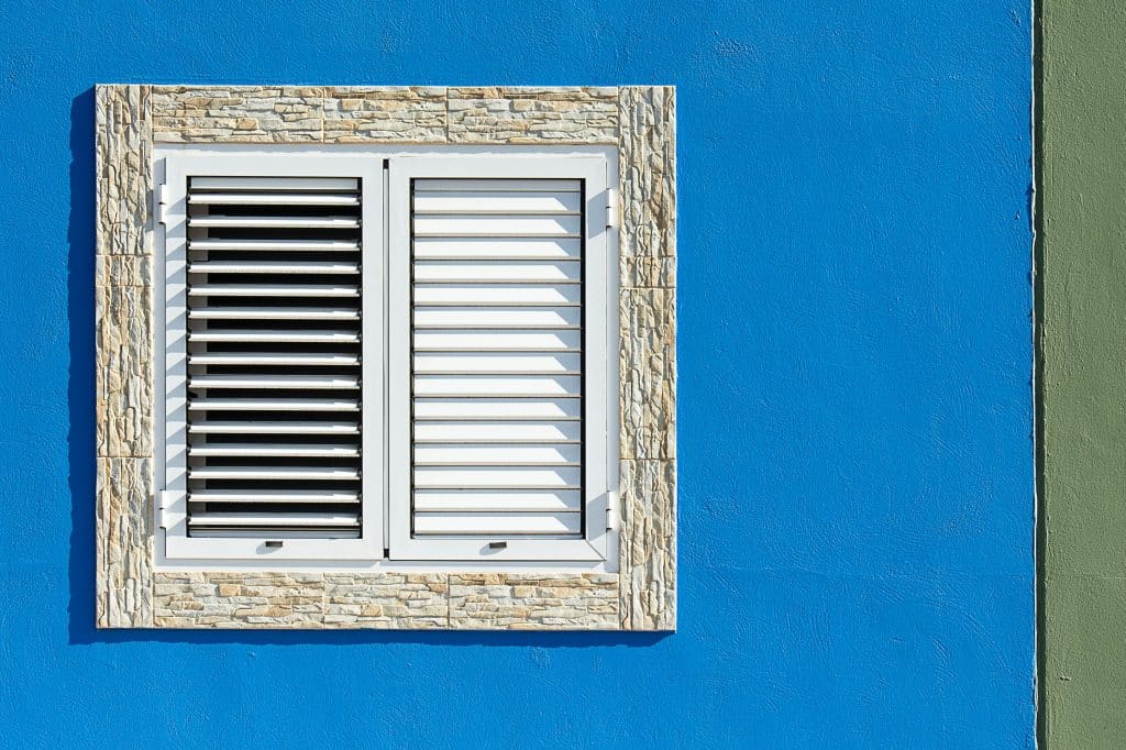 white shutters on blue wall
