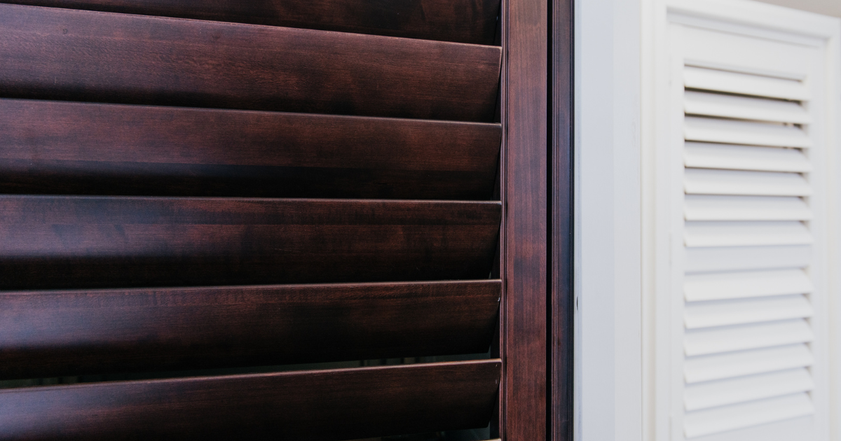 dark timber and white plantation shutters side by side